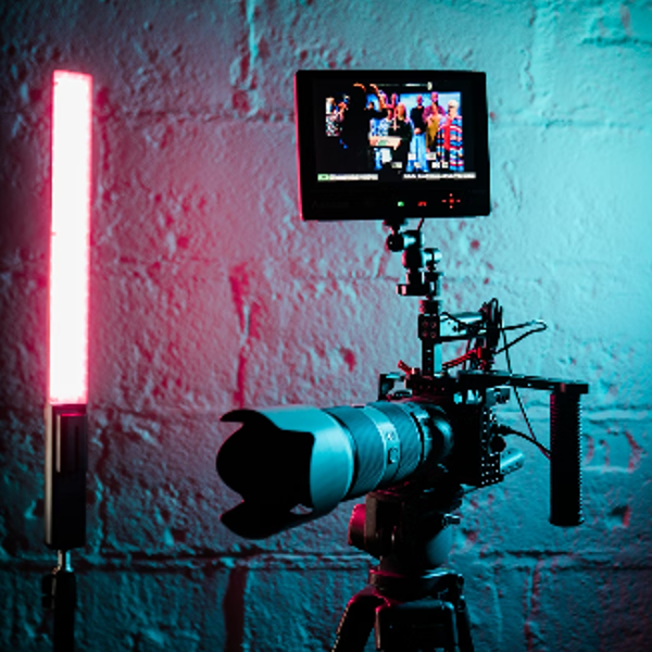 a camera set up in front of a brick wall