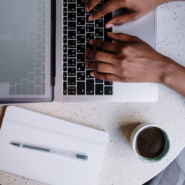 Person Using Macbook Pro on White Table