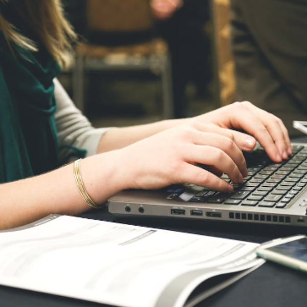 Woman Typing on Laptop