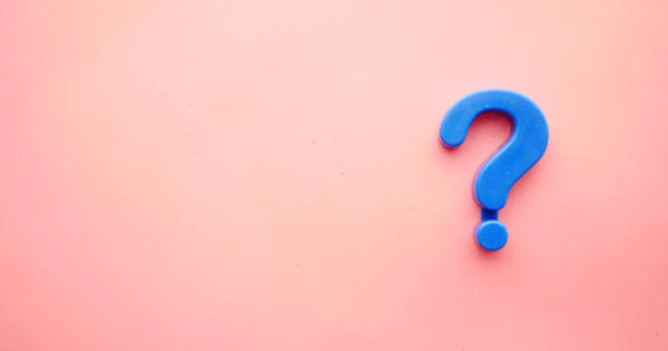 a blue question mark on a pink background