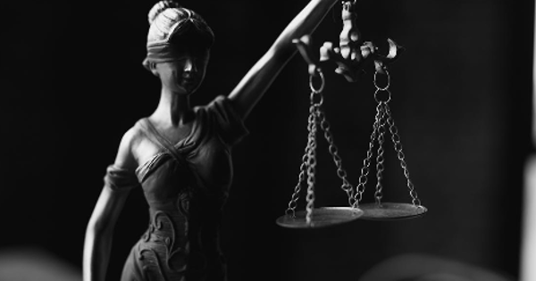 A Grayscale of a Lady Justice Figurine