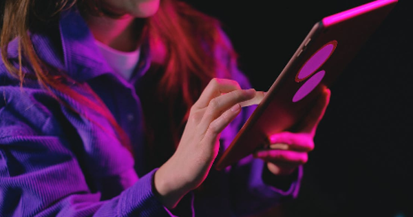 Anonymous woman browsing modern tablet