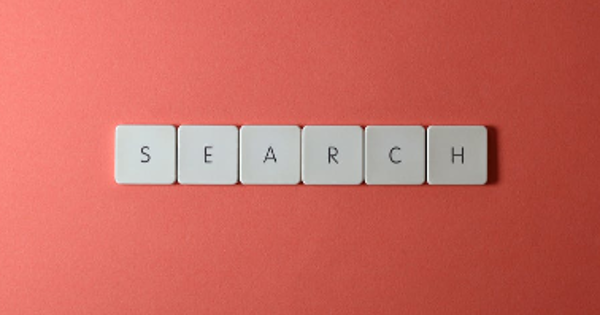 Close-Up Shot of Search Key Tiles on a Red Surface