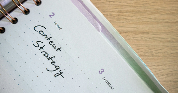 Desk with a planner with the words Content Strategy on it