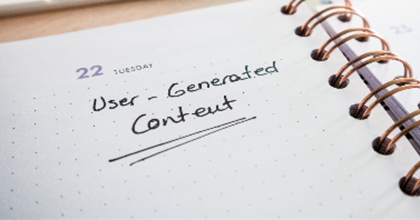 Desk with a planner with the words User-Generated Content on it