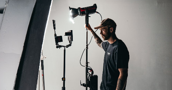 a man standing in front of a camera and lighting equipment