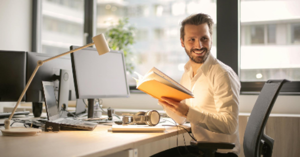 Photo of Man Holding a Book