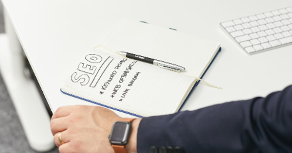 a person writing on a piece of paper