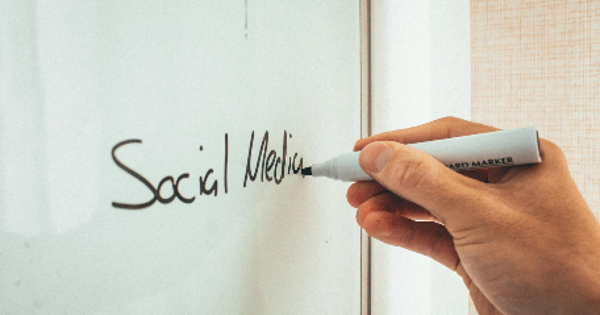 Unrecognizable man taking notes on whiteboard