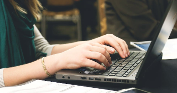 Woman Typing on Laptop