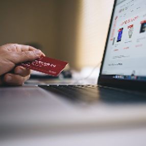 Computer Beside Person Holding Red Smart Card 