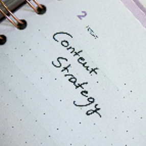 Desk with a planner with the words Content Strategy on it