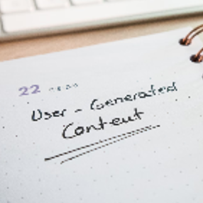 Desk with a planner with the words User-Generated Content on it