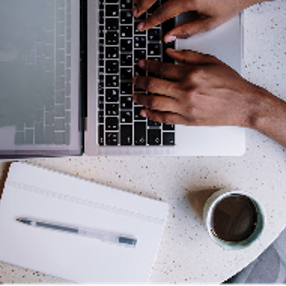 Person Using Macbook Pro on White Table