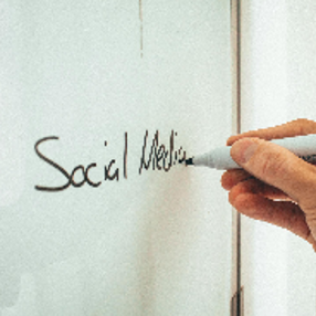 Unrecognizable man taking notes on whiteboard