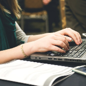 Woman Typing on Laptop